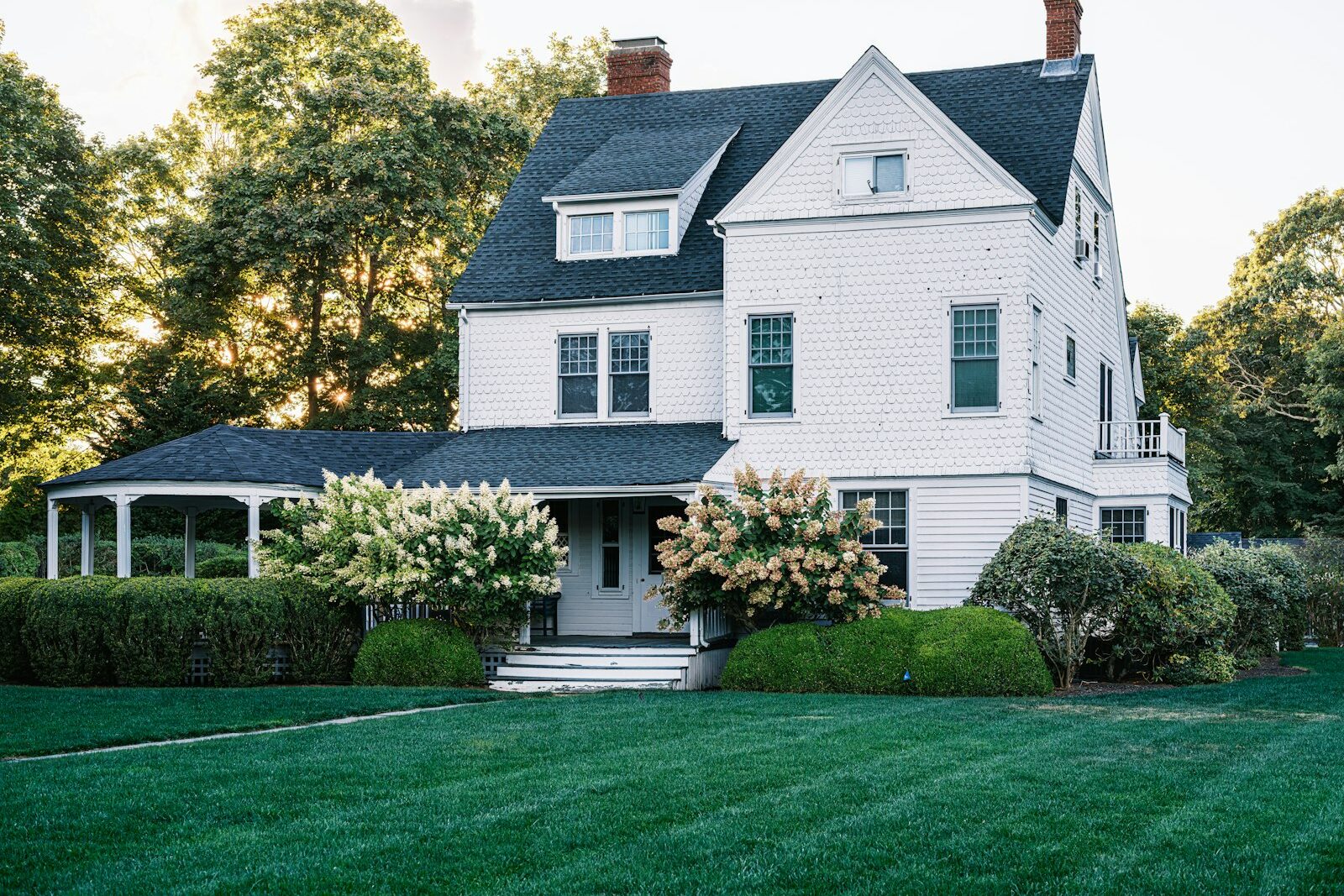 White two-story house with fresh exterior paint and green lawn