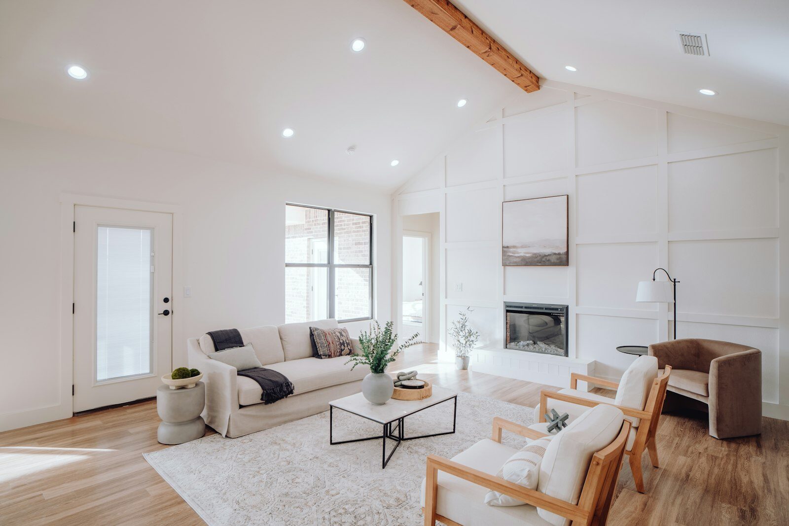 Bright living room with smooth white walls and paneled accent wall